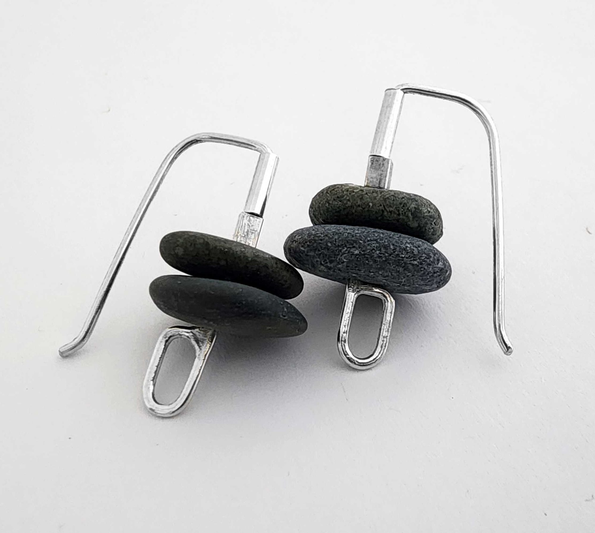 2 soft grey Okarito beach pebbles in minimal wire forged sterling silver ear wires